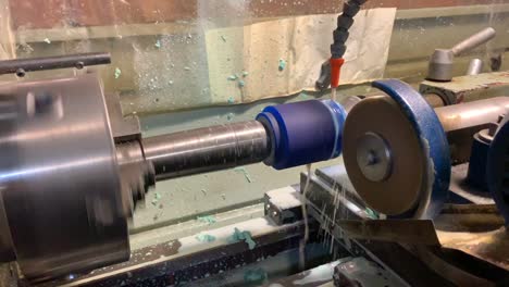 turner removes the roller from the turning and milling machine