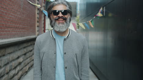 smiling man with thumbs up in an urban alley