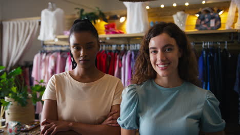 portrait of two serious female owners or workers in fashion clothing store