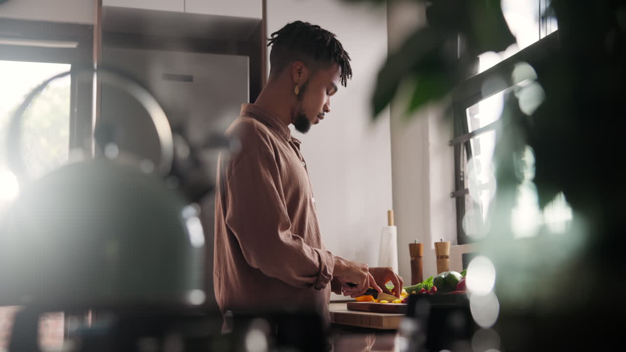 Man Chopping Vegetables in a Kitchen