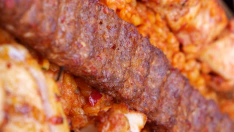 close-up of adana kebab and other food items