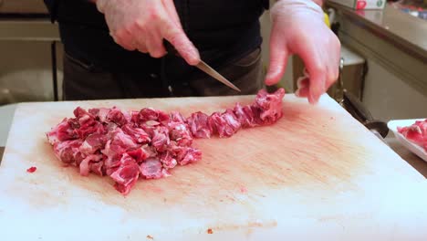 Cutting-raw-meat-on-chopping-board-at-local-store