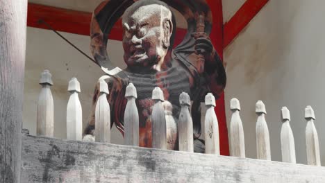 slide shot of a guardian protecting the temple in kyoto, japan 4k slow motion, close up