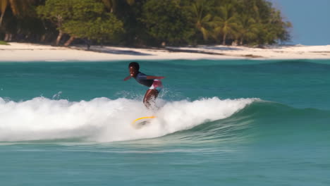 young person surfing on a tropical beach