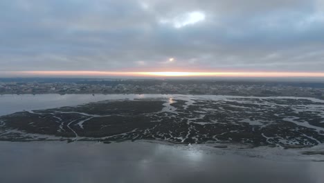 Aerial-view-during-sunrise-of-a-natural-reserve-and-it´s-river