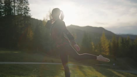 Slow-motion:-A-young-woman-doing-Natarajasana-on-a-platform-at-golden-hour