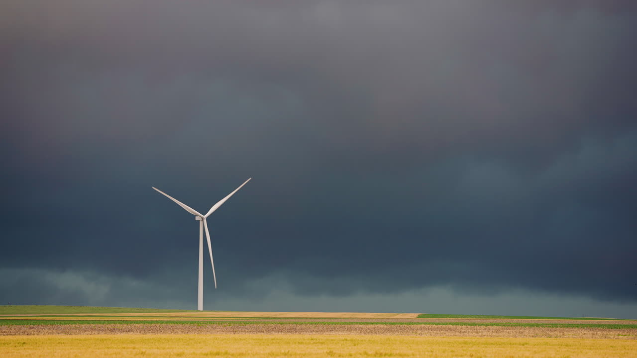 Wind Turbine in a Field Under Dark Stormy Skies
