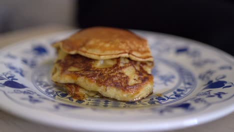 anonymous person eating tasty pancakes