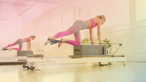 woman exercising on pilates reformer machine with light bokeh animation