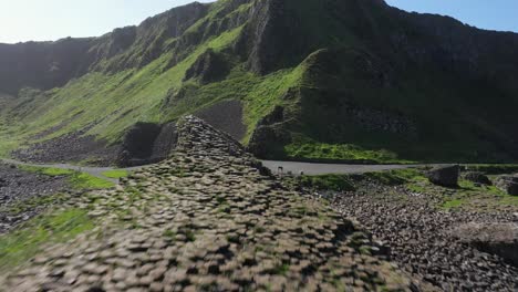 the giants causeway lies at the foot of the basalt cliffs along the sea coast on the north shores of county antrim