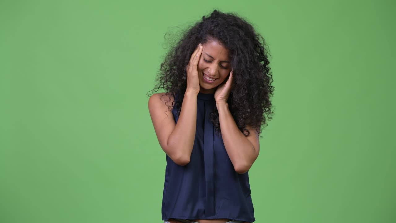 Young beautiful Hispanic businesswoman having headache