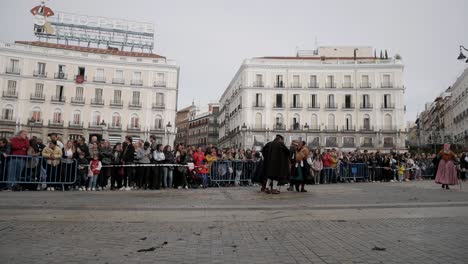 people standing on a fence, waiting for traditional animal march through the city of madrid, center, spain, trashumancia festival, static shot
