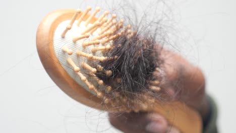 wooden hairbrush with hair loss