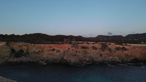 Drone-view-of-the-cliffs-on-the-beach,-historical-stone-ruins