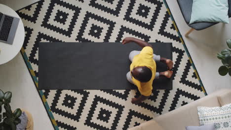 afro-american man stretching at home