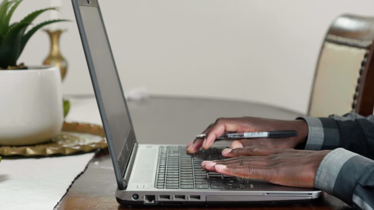African man working on laptop close up shot