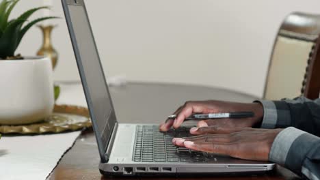 african man working on laptop close up shot
