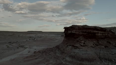 Flying-close-by-a-desert-butte-at-sunset-near-Hanksville,-Utah