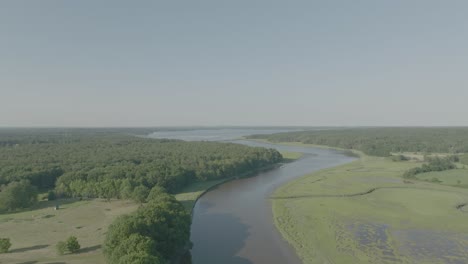 Rising-Drone-shot-above-winding-river-and-forest,-New-Hampshire