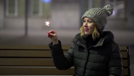 woman with sparklers at night