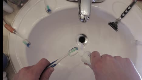 toothpaste is put on a toothbrush