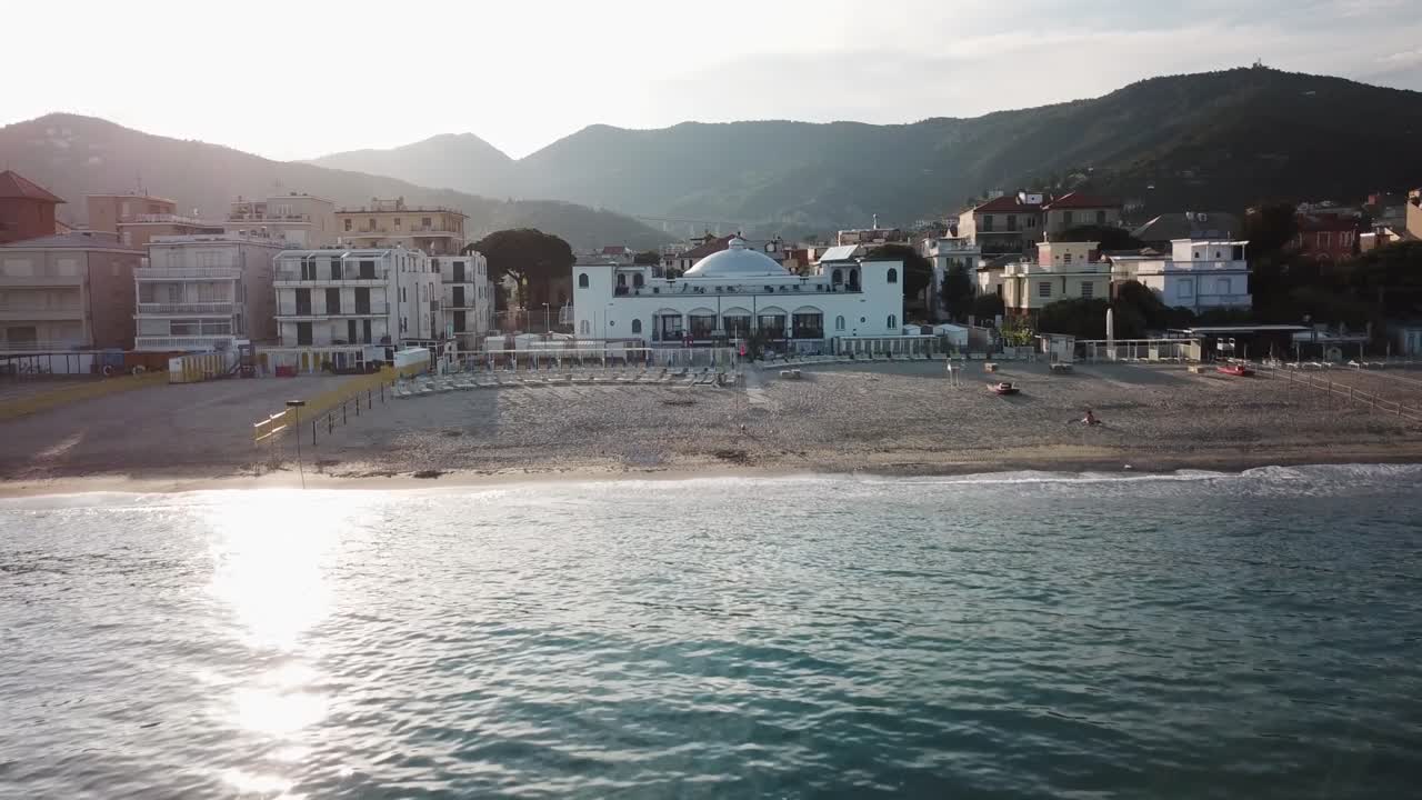 Drone view of an hotel behind a sandy mediterranean beach. genoa, Italy