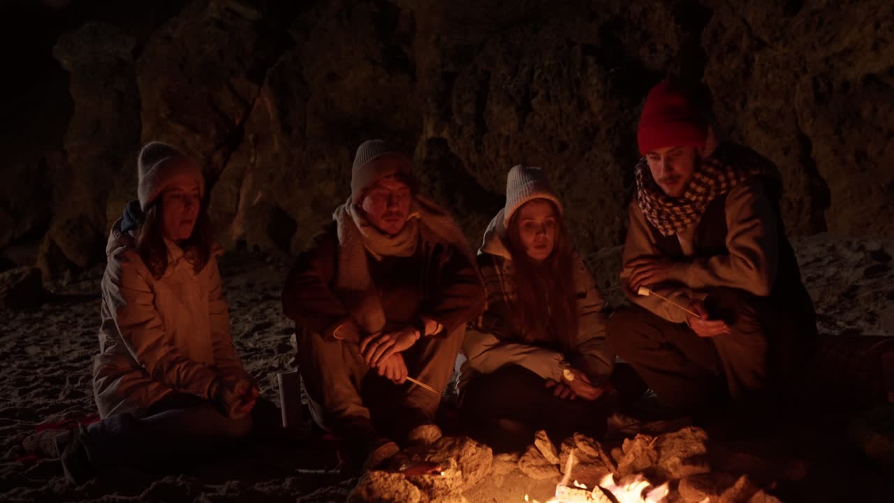 Friends Enjoying a Campfire on a Winter Beach Night