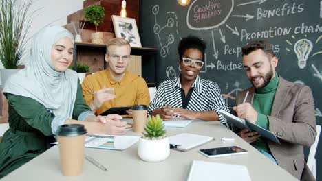 portrait of happy businesspeople making video call smiling clapping hands enjoying successful project