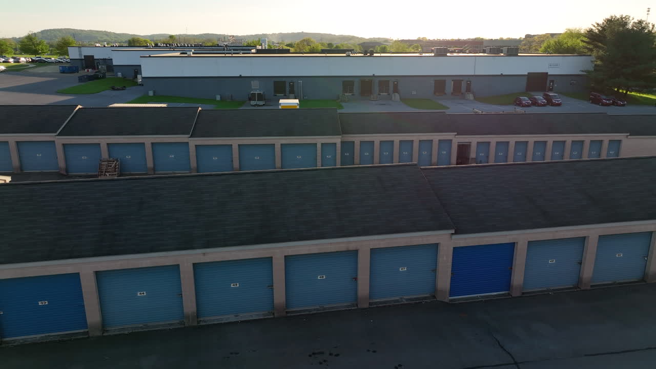 Self storage units. Locked garage doors protect personal goods. Aerial view during spring sunset.