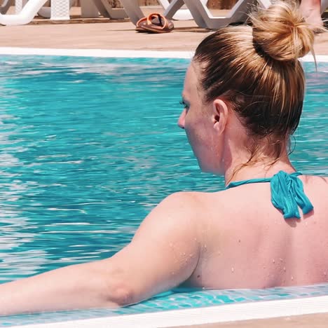 sensual young woman relaxing in swimming pool.