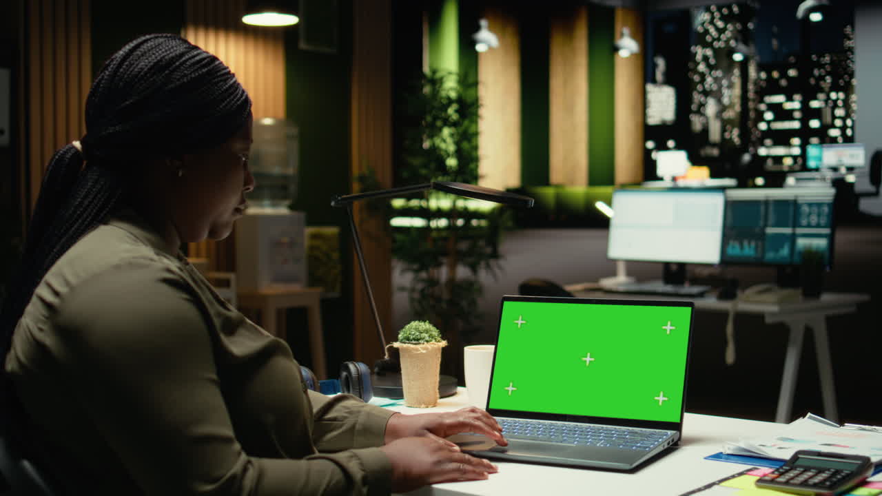 Green screen on gadget where young black specialist finishing management tasks