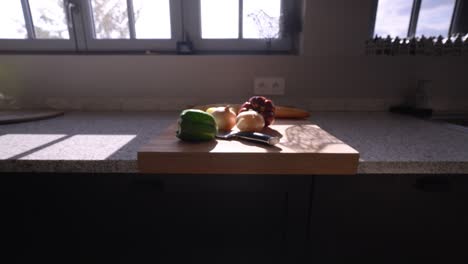 slow establishing shot of a selection of vegetables sitting on a chopping board