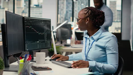 day trader analyzes stock exchange price candlestick graphs
