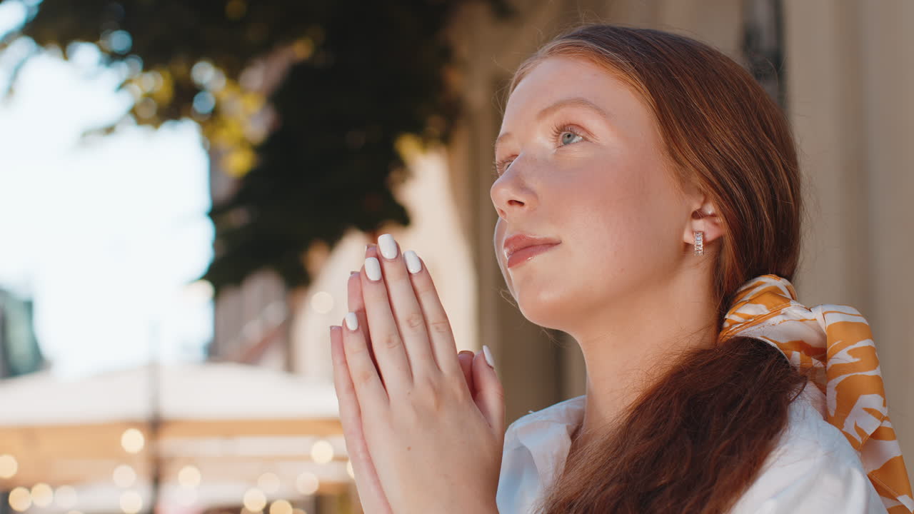 Portrait of teenager girl praying closed eyes to god asking for blessing help forgiveness outdoors