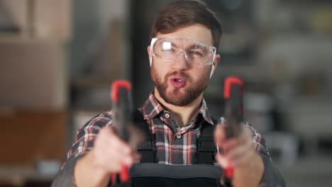 close-up portrait of a worker in uniform who shoots with carpentry clips