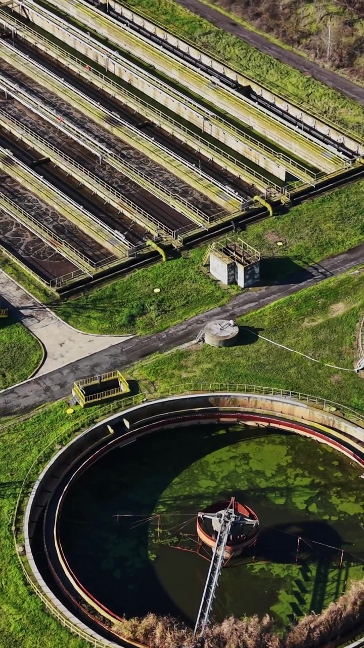 Aerial view of a water treatment facility with large circular tanks