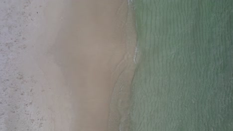 clearwater waves on white sand beach on the gulf of mexico aerial view