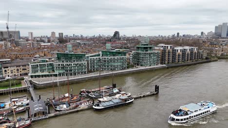 Riverside-apartments-and-houseboats-pull-back-drone-aerial-reverse-reveal