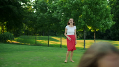 Children-and-parents-playing-with-ball-in-meadow.-Family-having-fun-together