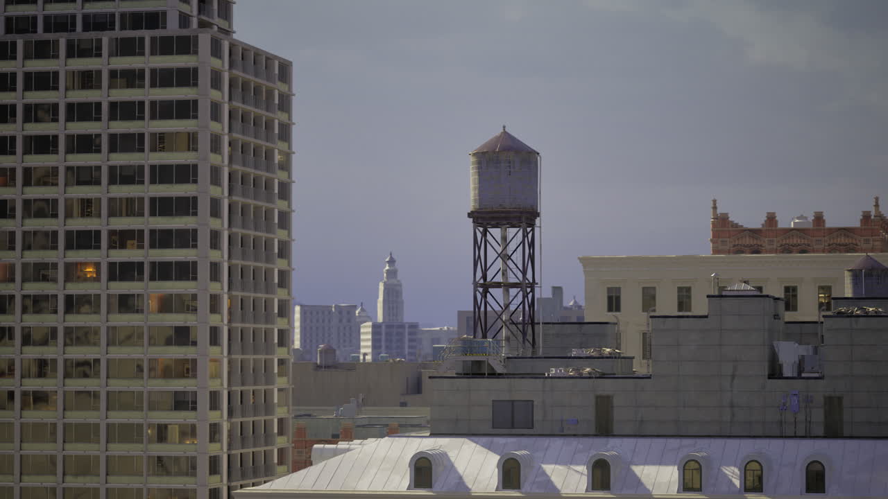 Old water tower stands tall among modern buildings in urban skyline