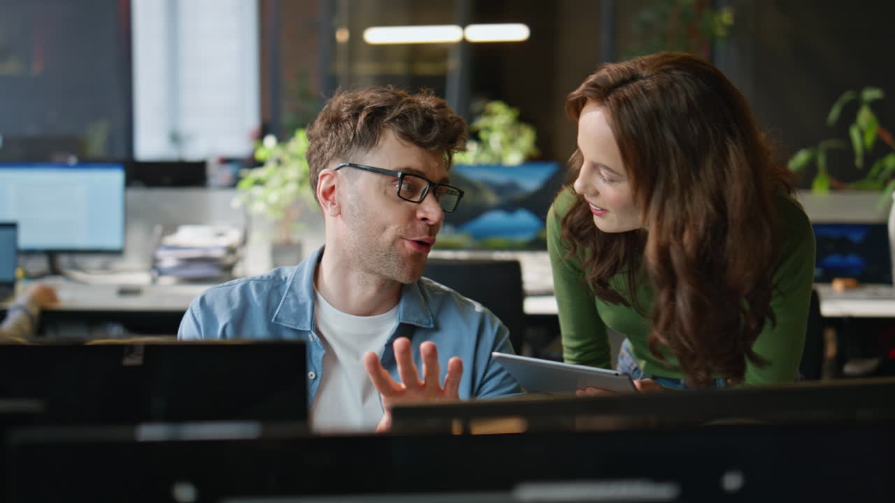 Smiling businesswoman checking trainee work in agency closeup. Happy colleagues