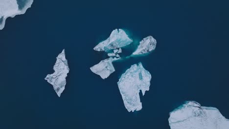 aerial top view over icebergs in the glacial water of jokulsarlón lake, in iceland, during winter