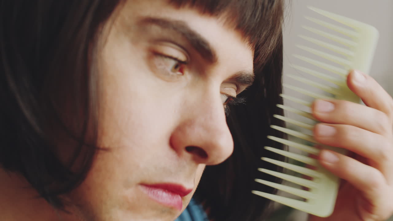 Transgender Man Brushing Wig Hair with Comb