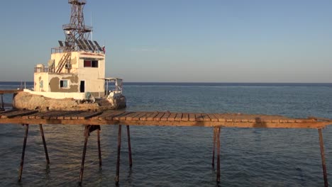 original daedalus reef lighthouse and pier in evening golden light