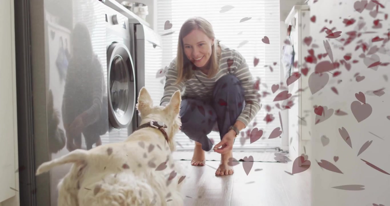 Woman Playing with Her Dog in Laundry Room with Floating Heart Graphics