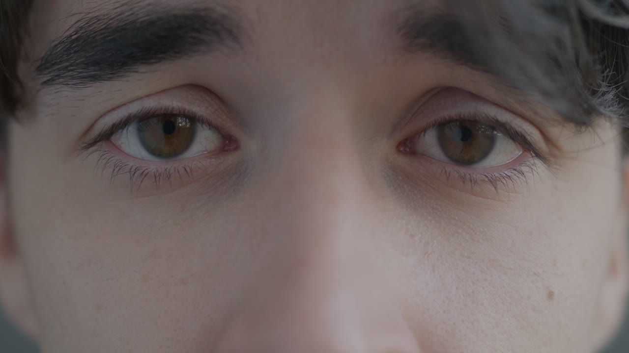 Close-up of a person's face with eyes open and closed