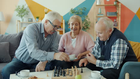 elderly friends enjoying a game of chess at home