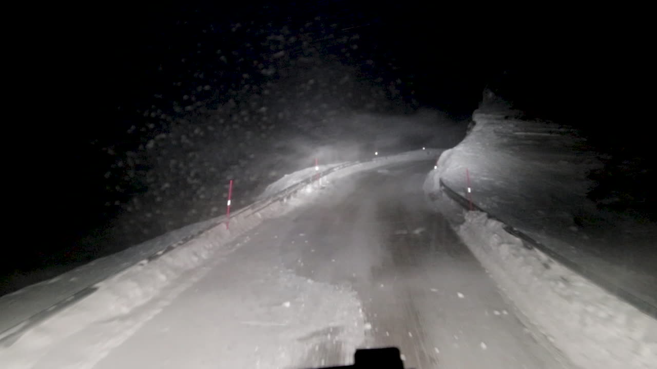 POV shot of the poor visibility and dangerous road conditions heavy haul logistics truck drivers have to endure to ensure stability in the consumer goods supply chain in northern Europe, Soroya Norway