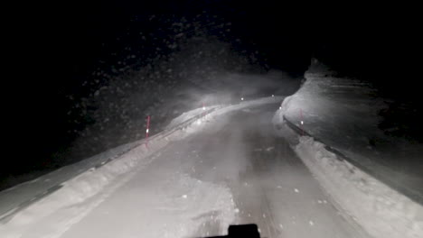 pov shot of the poor visibility and dangerous road conditions heavy haul logistics truck drivers have to endure to ensure stability in the consumer goods supply chain in northern europe, soroya norway