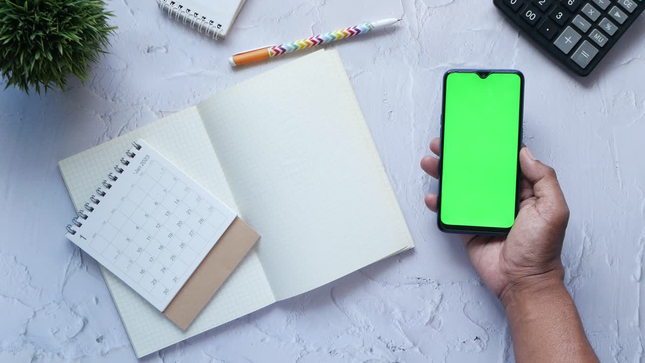 Deadline concept with mans hand marking date on calendar top view